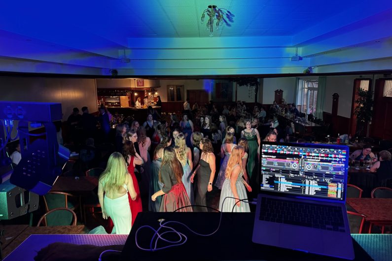 Feiernde Mädchen auf einem Abiball, DJ Pult im Vordergrund